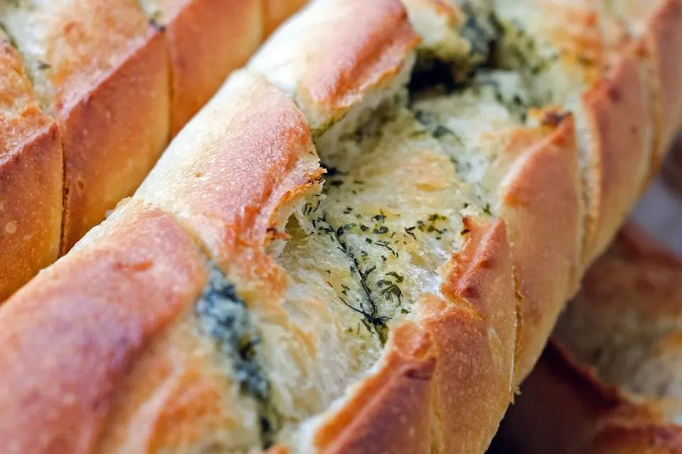 Baguette with herbs and cheese on top of it