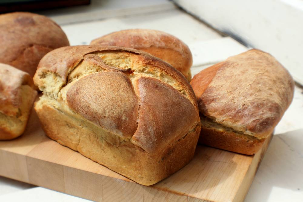 Few homemade breads on a wooden plate