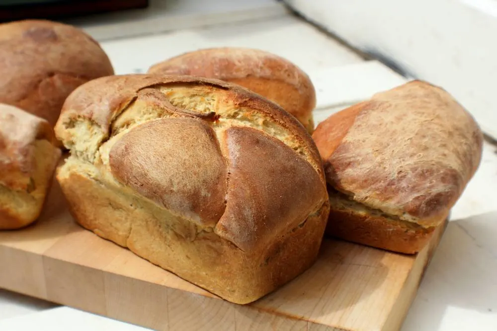 Few homemade breads on a wooden plate