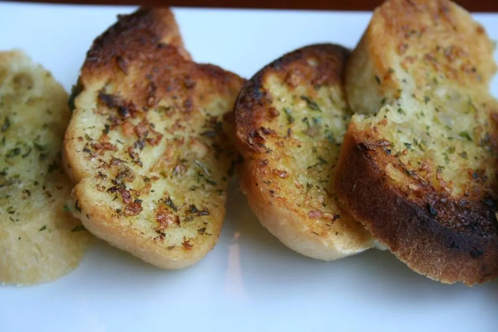 Sliced baked bread with garlic and olive oil