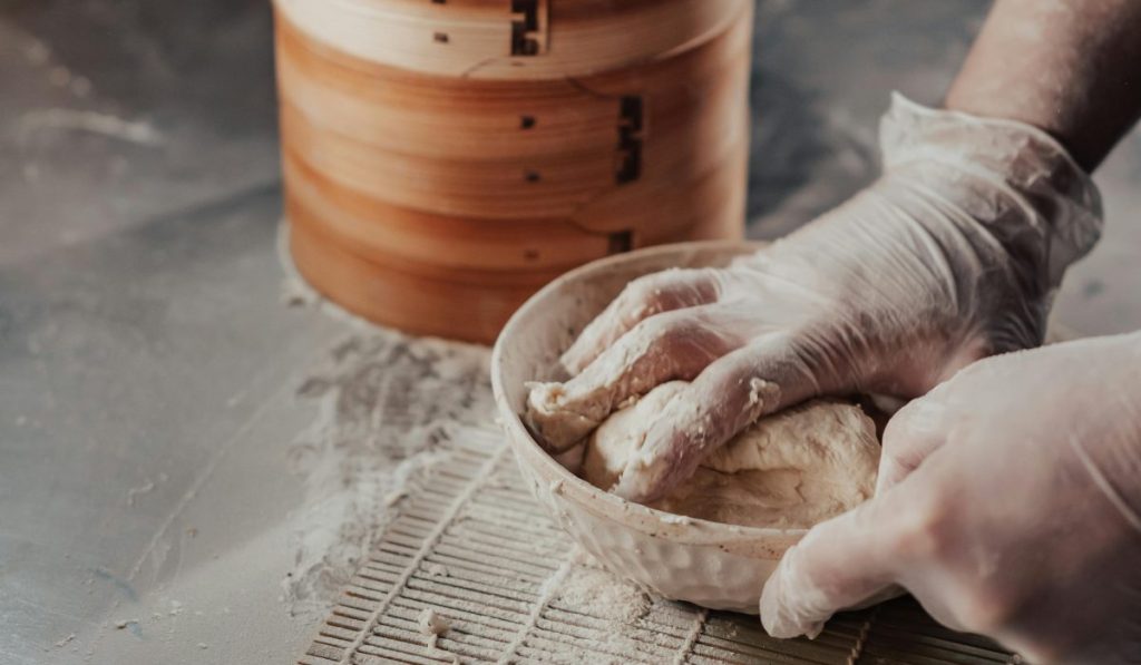 Mixing Dough for Keto Bread with hands in the Bowl