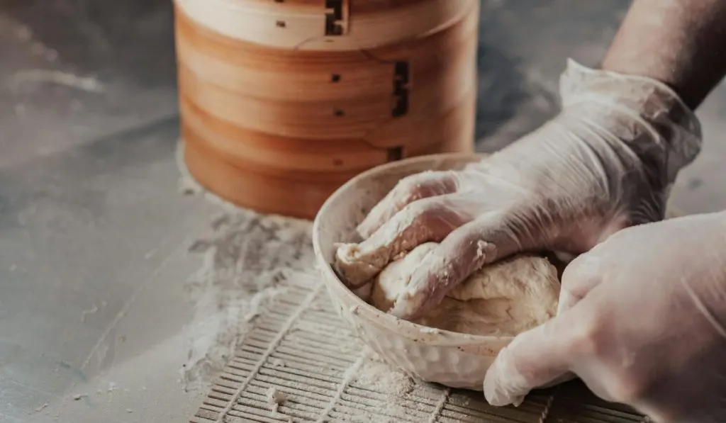 Mixing Dough for Keto Bread with hands in the Bowl