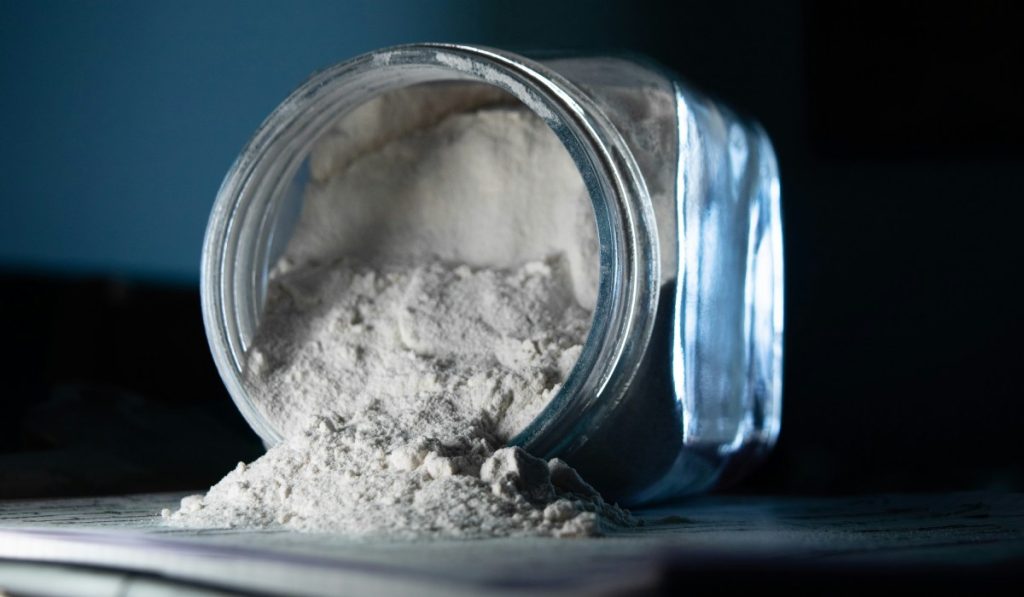 A jar with flour spilled on table