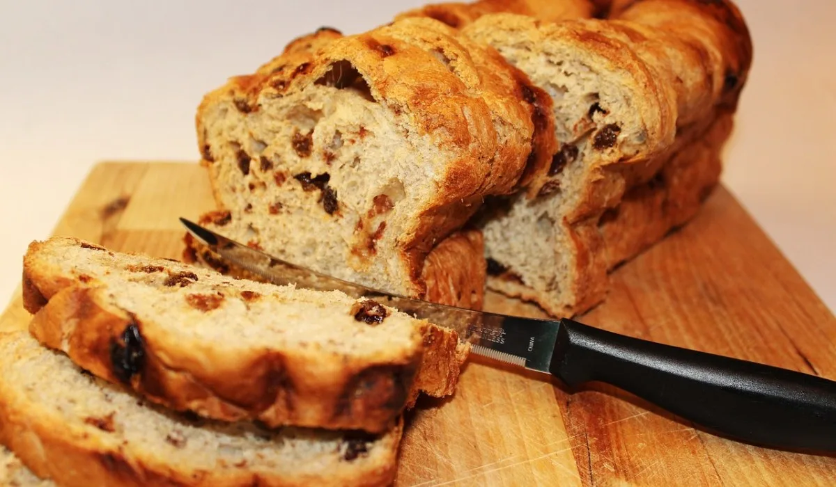 Sliced raisin bread on a wooden plate