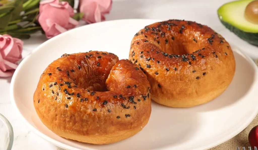 Two Sourdough Bagels on a white plate