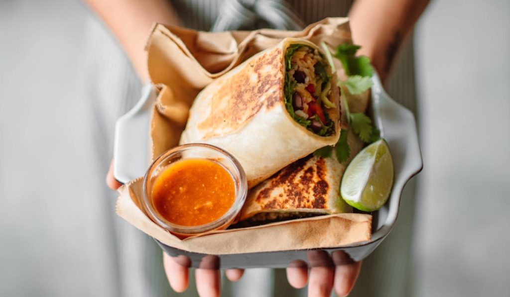 Woman holding tortilla in hands